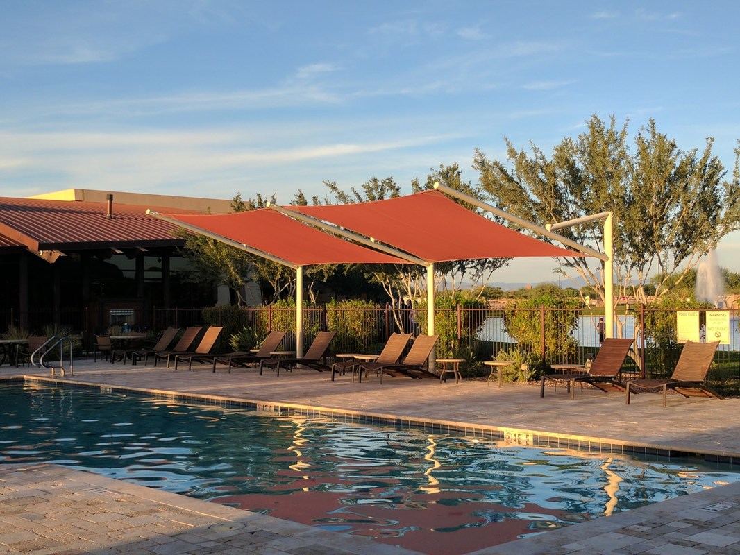 Tensioned residential shade sail over an outdoor sitting area