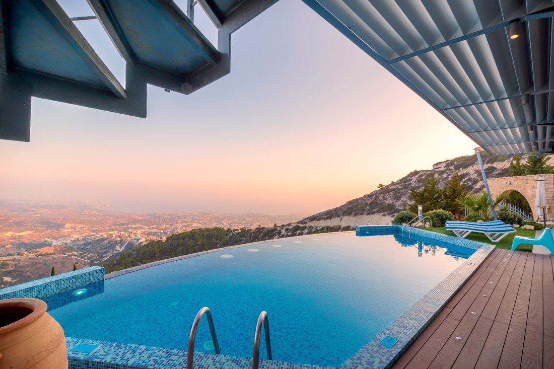 Pool shade sail protecting a swim and lounge area